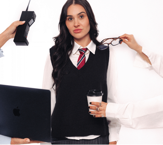 Creative professional holding glasses and coffee while working with a laptop